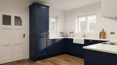 Navy shaker kitchen with white worktops and brass handles