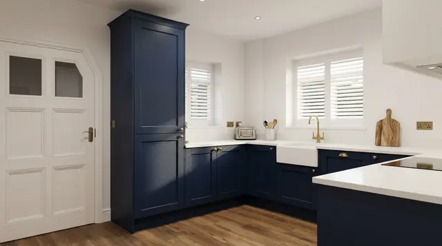 Navy shaker kitchen with a tall larder unit, white quartz-effect worktops, a ceramic sink with a brass tap and white shutters