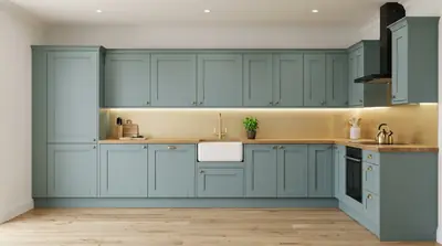 Sage green shaker kitchen with oak worktops and a ceramic sink